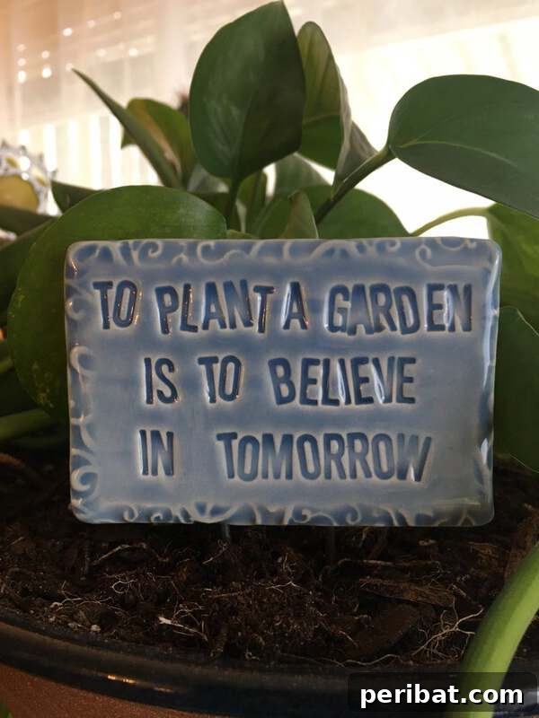 Ceramic garden sign with the quote 'To plant a garden is to believe in tomorrow'