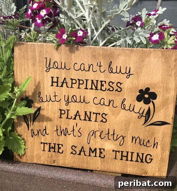 Wooden slat sign with the quote 'You can't buy happiness, but you can buy plants and that's pretty much the same thing'