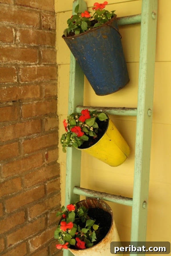 Green vintage ladder with buckets holding plants