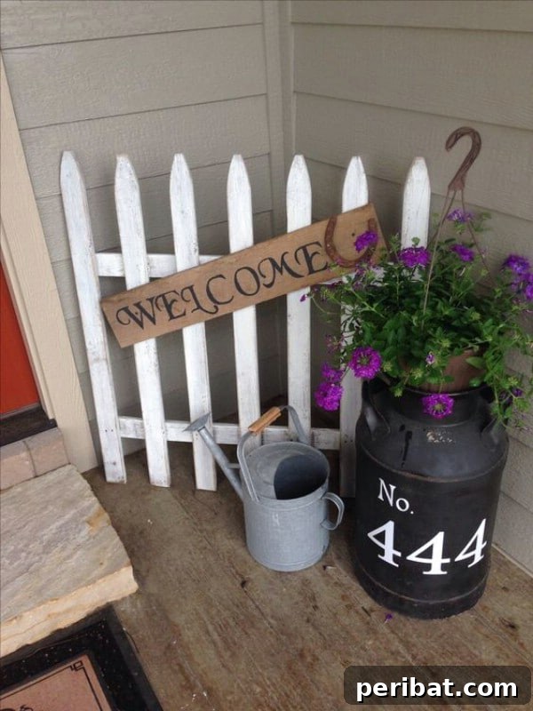 White picket fence repurposed as a welcome sign with house numbers
