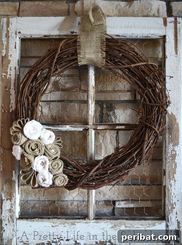 Grapevine and burlap wreath on an old weathered window frame