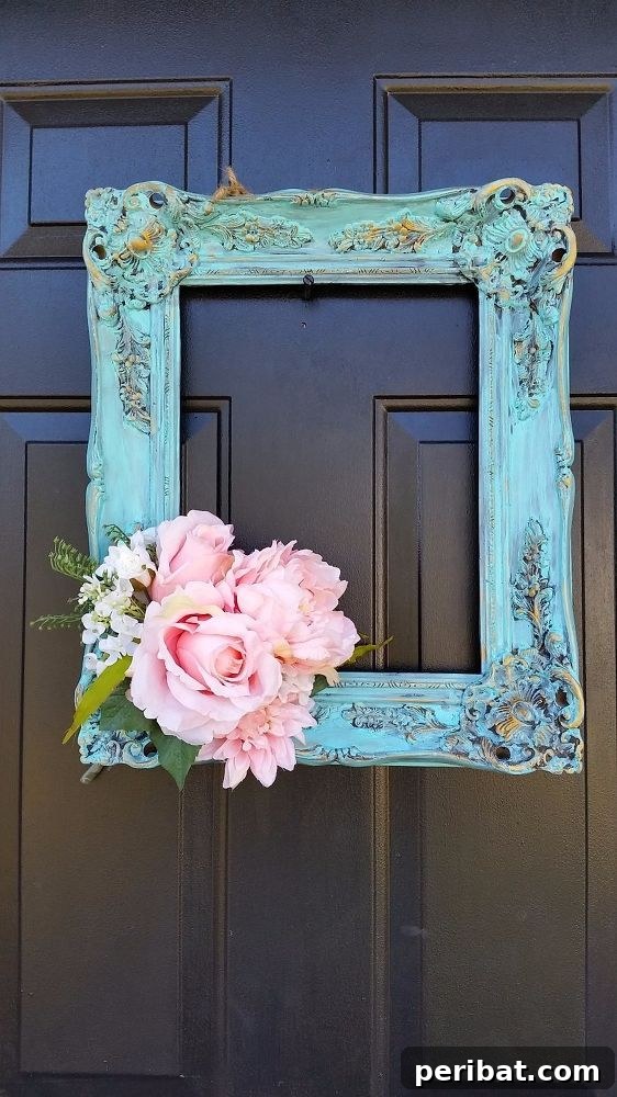 Teal ornate frame on a black door as a unique wreath