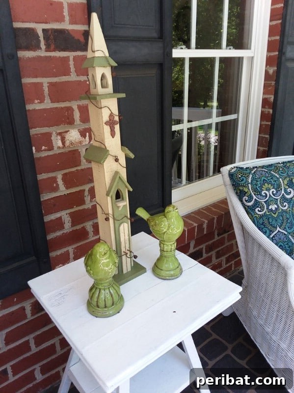 Green ceramic birds and a birdhouse on a side table