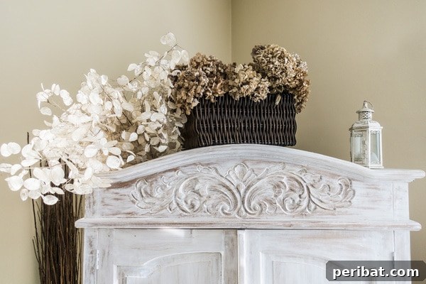 Creating Your Rustic Bedroom Oasis 6 Weathered white armoire with rustic floral and basket accents
