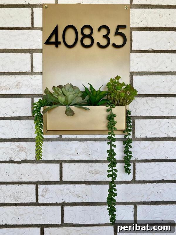 Smart DIY Integrated Planters for Maximizing Tiny Outdoor Areas 12 A modern address sign featuring house numbers and an integrated planter box for succulents.
