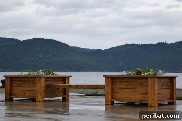 Smart DIY Integrated Planters for Maximizing Tiny Outdoor Areas 31 Square wooden planters integrated as part of a bench in an outdoor setting.