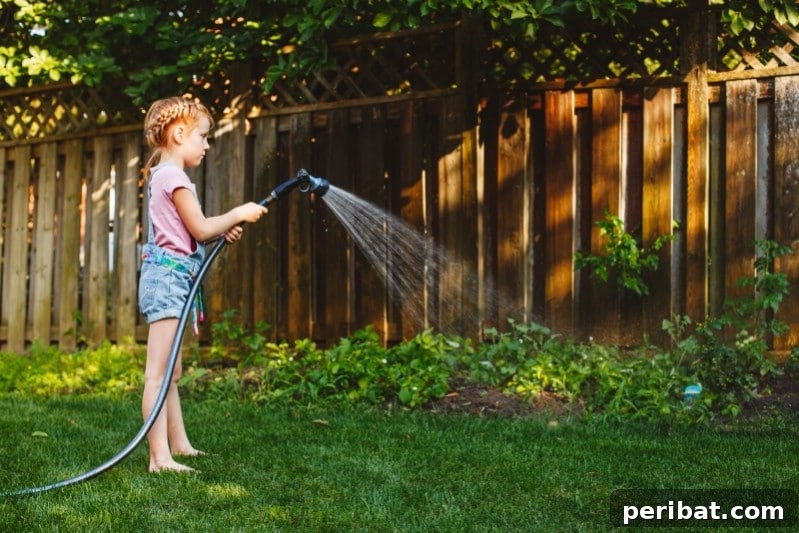 Little girl watering the garden.