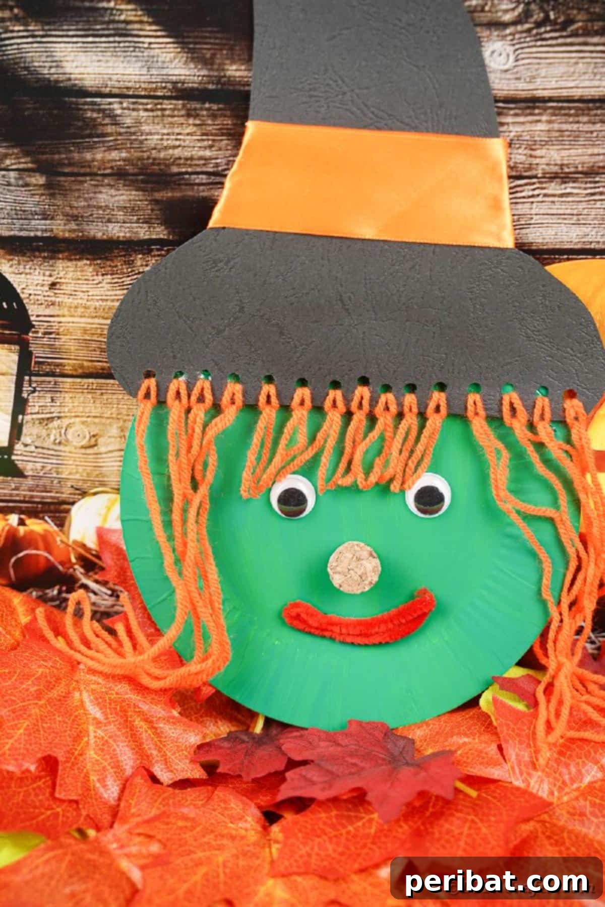 Spooktacular Paper Plate Witch Craft 30 Paper plate witch face displayed on artificial fall leaves