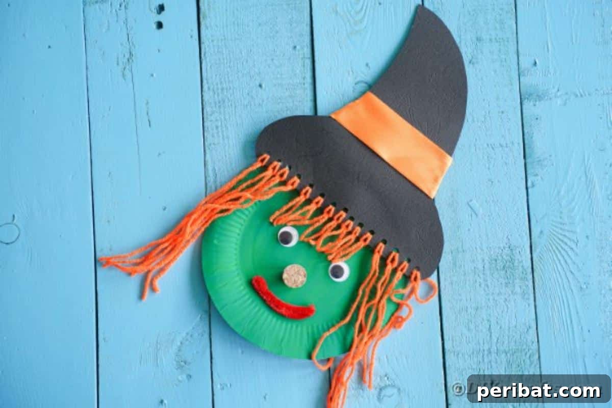 Spooktacular Paper Plate Witch Craft 6 Paper Plate Witch on a blue wooden background