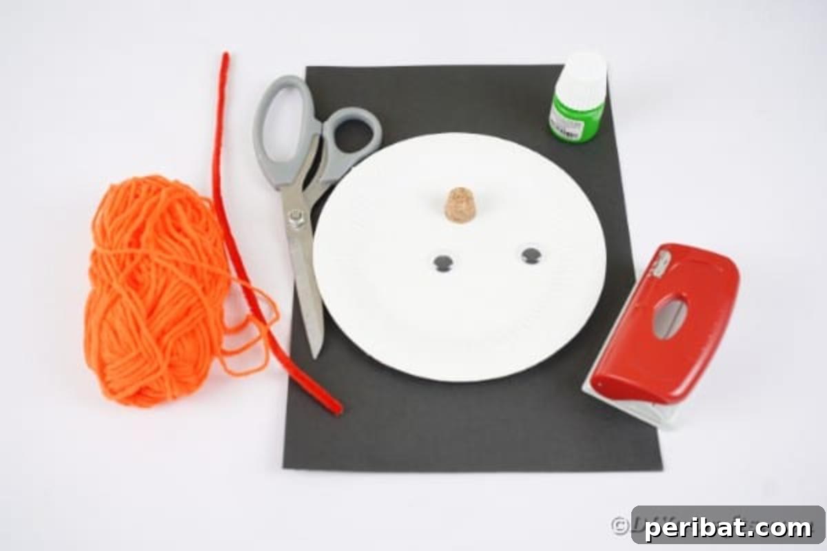 Spooktacular Paper Plate Witch Craft 7 Supplies laid out for making the paper plate witch