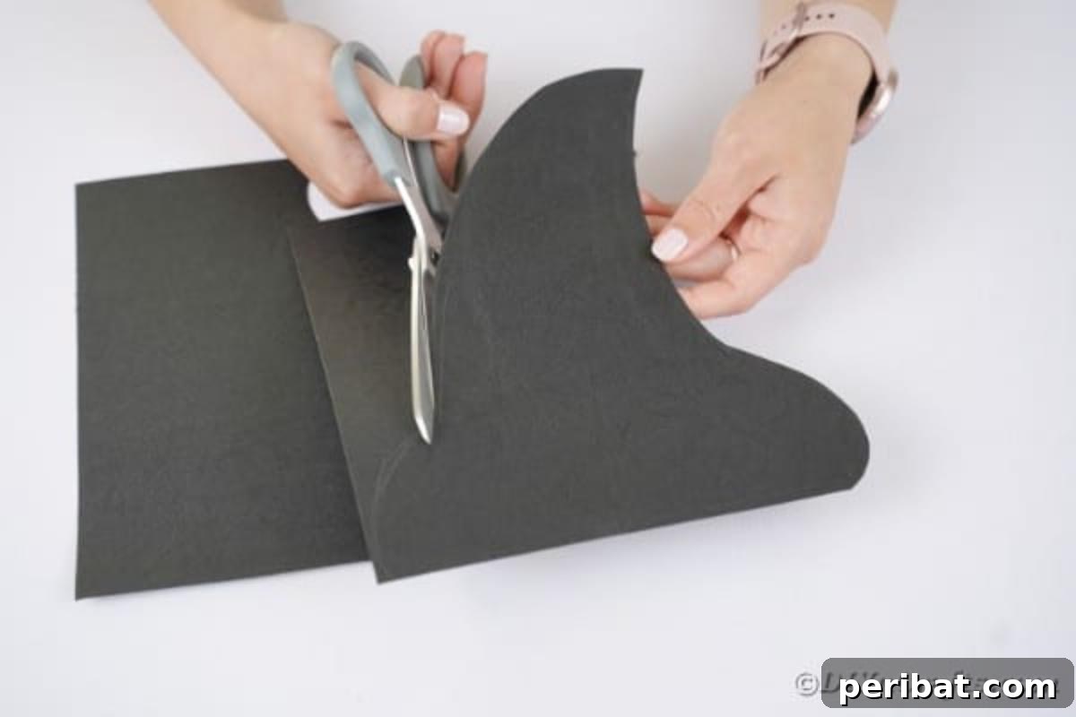 Spooktacular Paper Plate Witch Craft 9 Scissors cutting a hat shape from black paper
