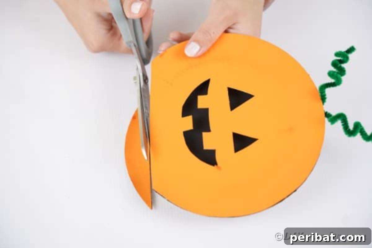 Grinning Gourd Lanterns: A Paper Plate Craft for Kids 15 Trimming the bottom edge of the joined paper plates to create a flat surface