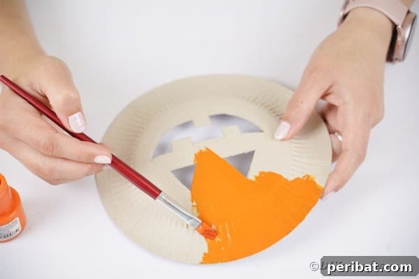 Grinning Gourd Lanterns: A Paper Plate Craft for Kids 20 Painting plate orange