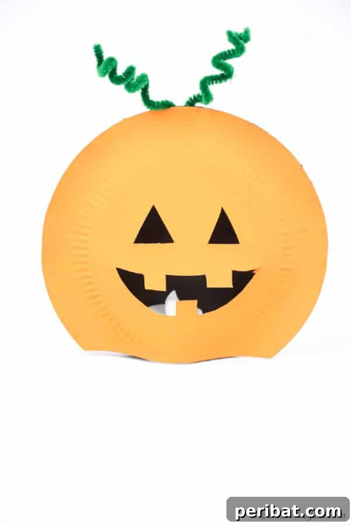 Grinning Gourd Lanterns: A Paper Plate Craft for Kids 24 A finished paper plate pumpkin lantern displayed on a white table