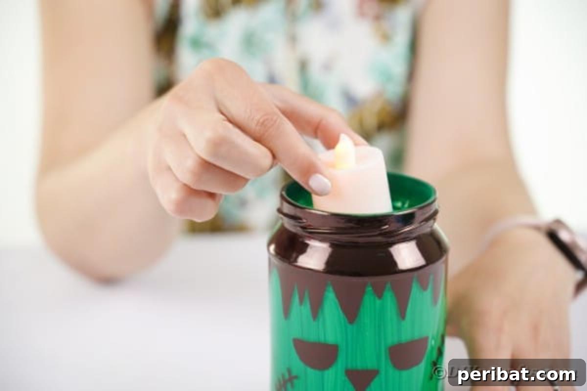 Charming Frankenstein Mason Jar Halloween Glow 12 Adding candle to mason jar