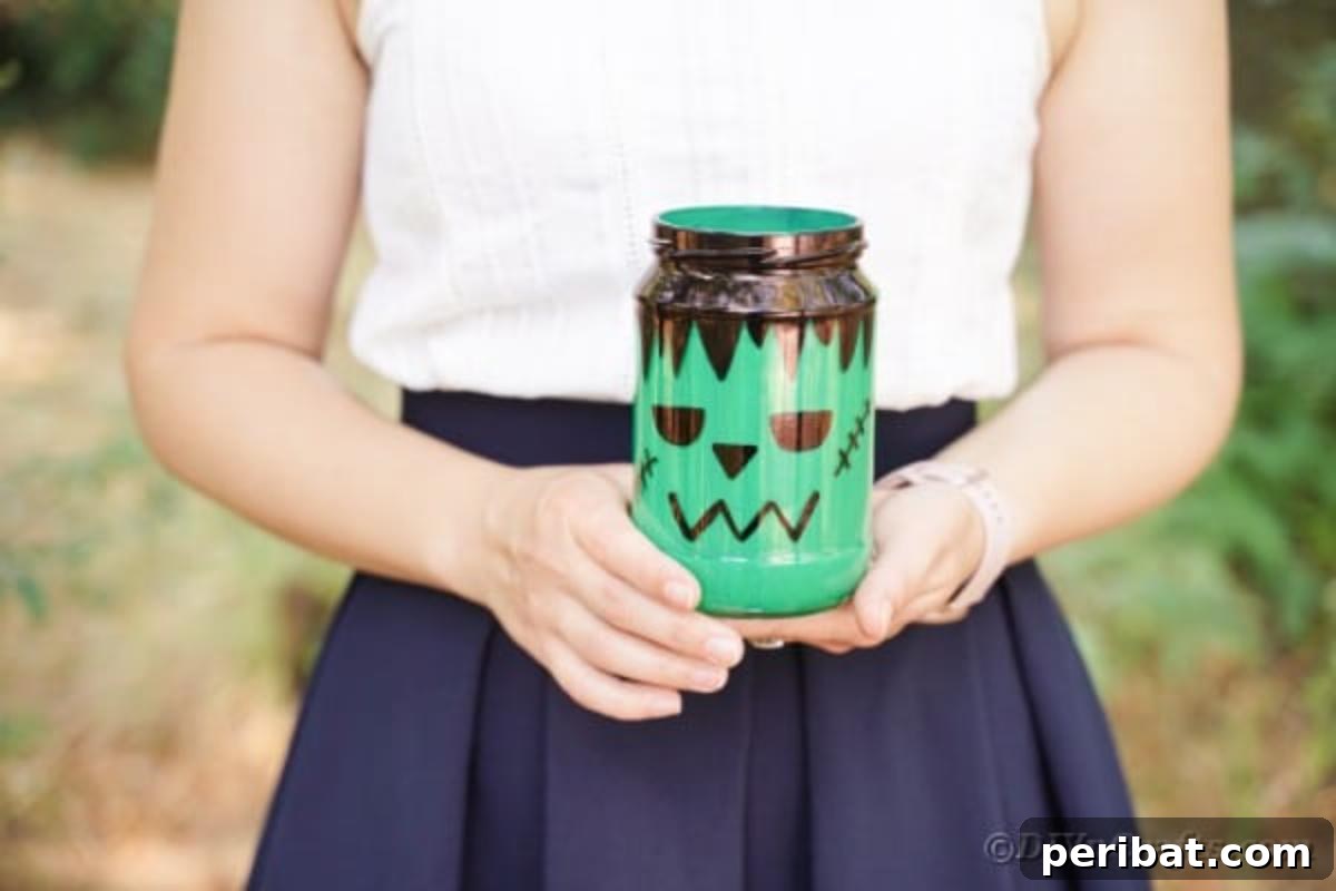 Charming Frankenstein Mason Jar Halloween Glow 3 Woman holding a mason jar frankenstein