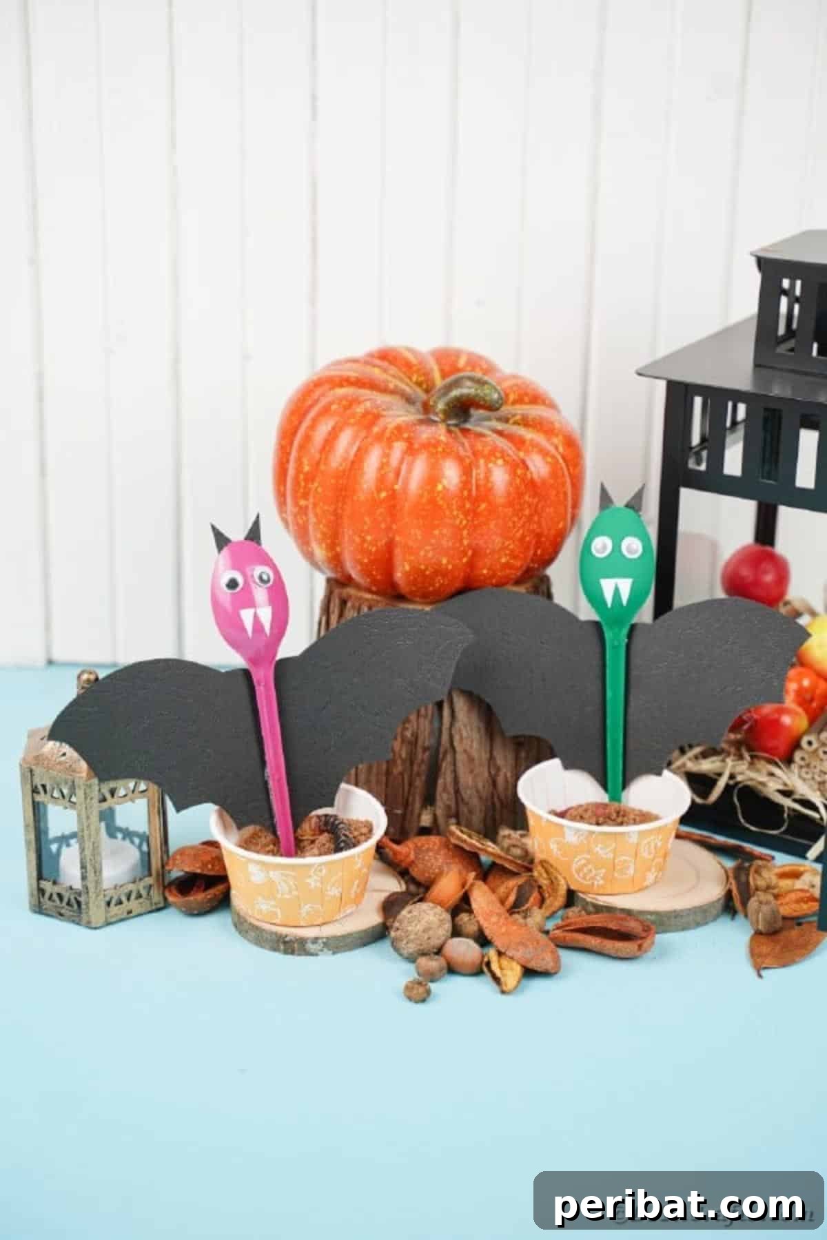 Adorable Recycled Plastic Spoon Bat Halloween Decor 17 A finished upcycled spoon bat gracefully displayed among other Halloween decorations, showcasing its vibrant color and charming design as a festive home accent.
