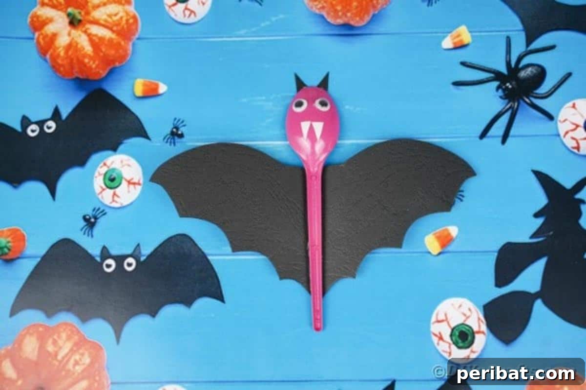 Adorable Recycled Plastic Spoon Bat Halloween Decor 6 A cheerful group of upcycled spoon bats, painted in various pastel colors with black wings and googly eyes, displayed against a blue background, perfect for a friendly Halloween theme.