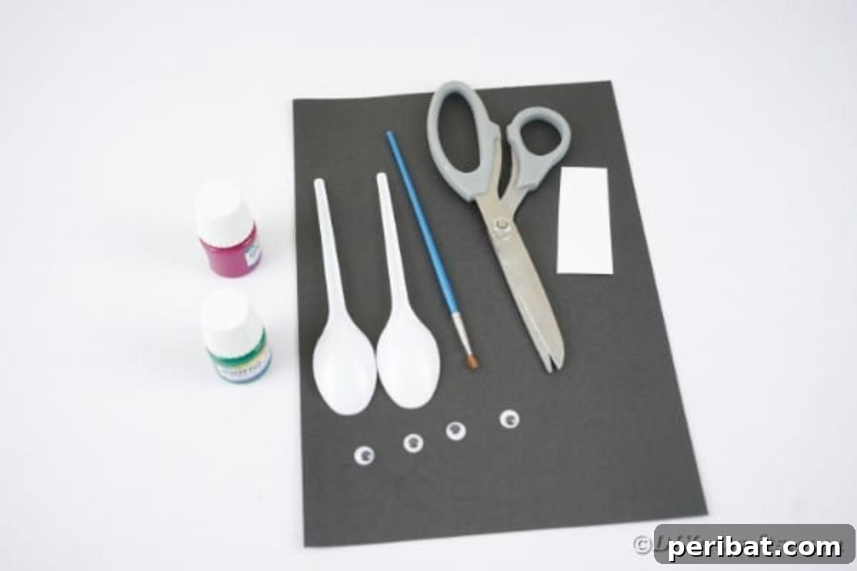 Adorable Recycled Plastic Spoon Bat Halloween Decor 8 A collection of crafting supplies for making spoon bats, including colorful spoons, black paper, googly eyes, scissors, and glue, laid out on a clean surface.