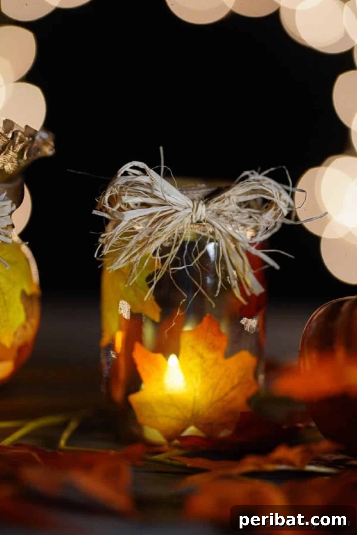 Autumn Leaf Jar Luminaries 17 A pair of beautifully illuminated fall leaf lanterns, casting a warm glow, perfect for an evening gathering on a porch or deck.