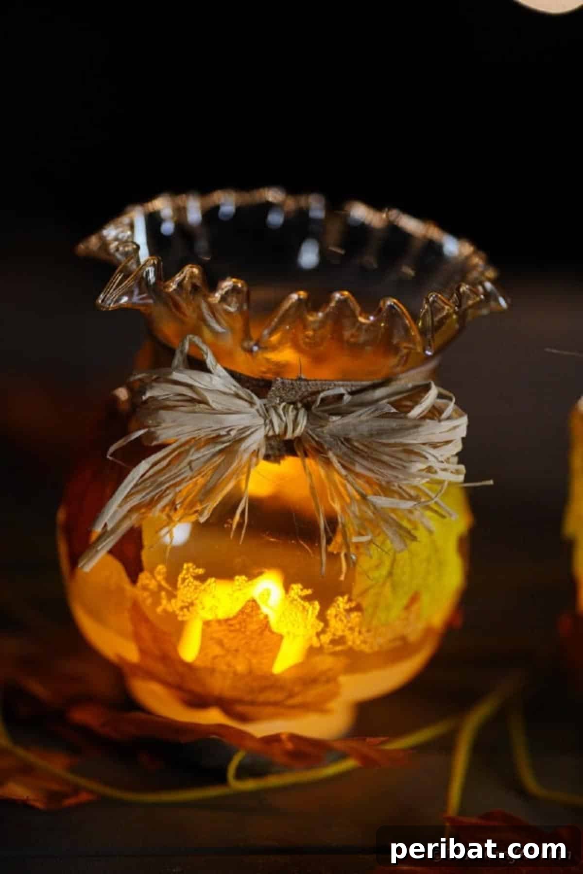 Autumn Leaf Jar Luminaries 18 A close-up of an upcycled glass globe lantern featuring intricate engravings and fall leaf decorations, highlighting its unique charm.