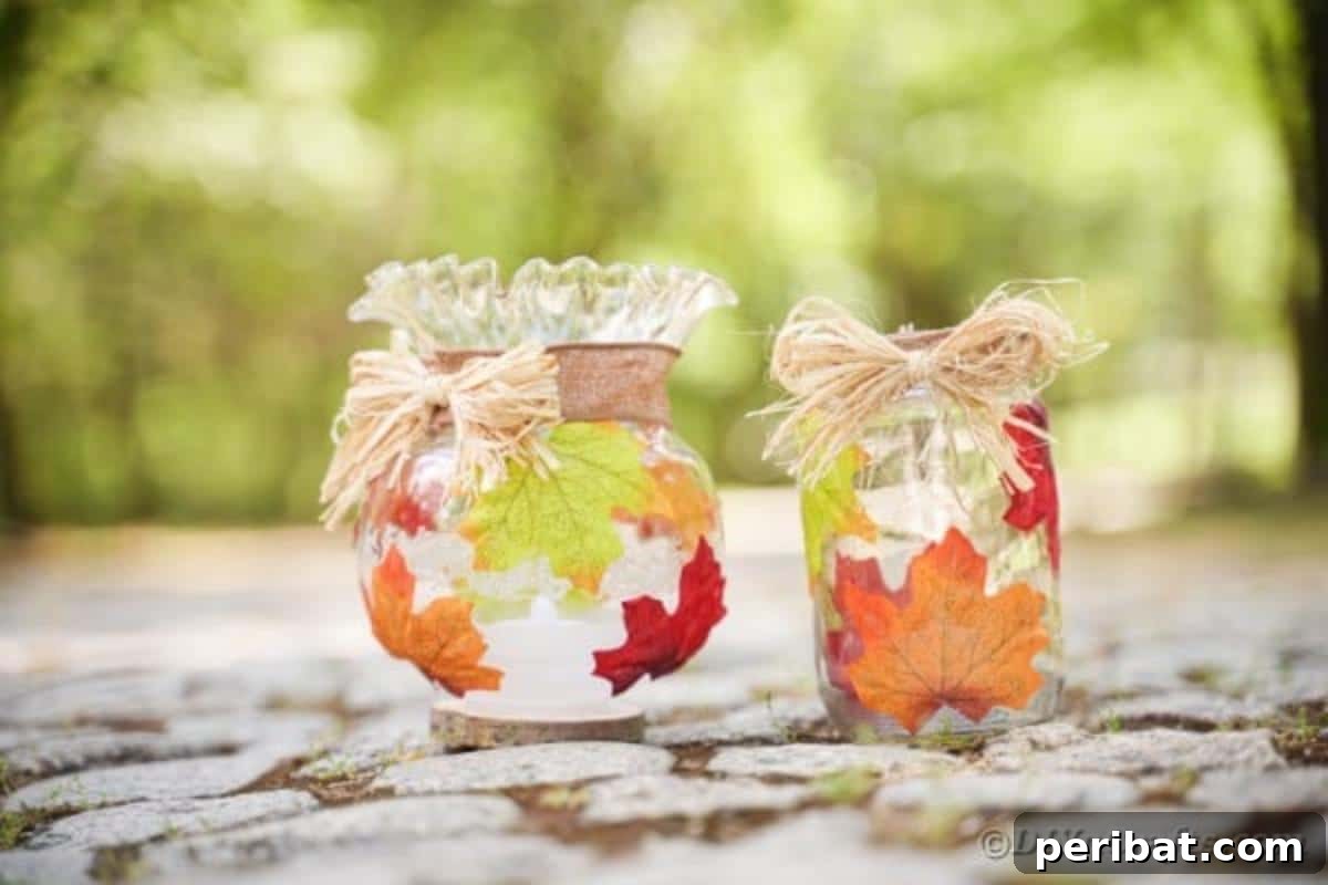 Autumn Leaf Jar Luminaries 5 Two intricately decorated fall leaf jars, illuminated from within, resting on a bed of natural rocks, creating a serene and earthy display.