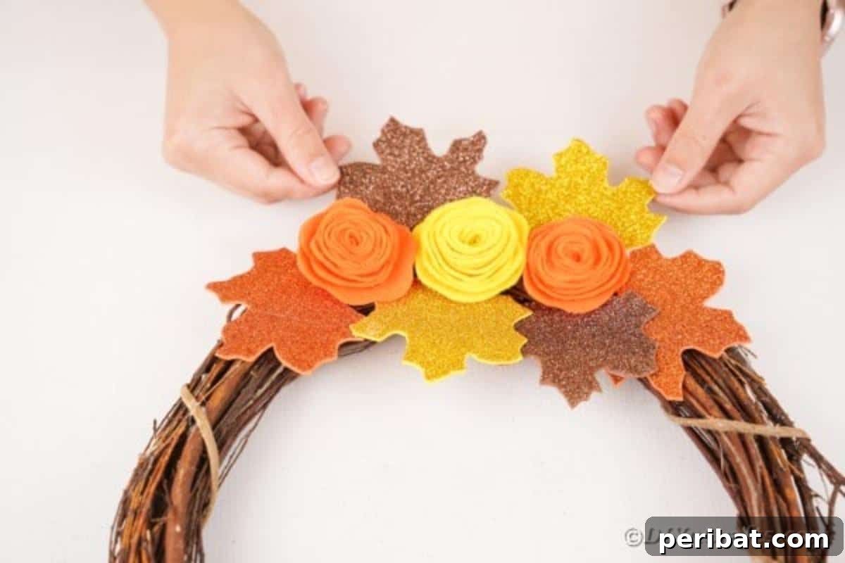 Autumn Grapevine Wreath with Soft Fabric Blooms 18 Adding leaves onto grapevine wreath
