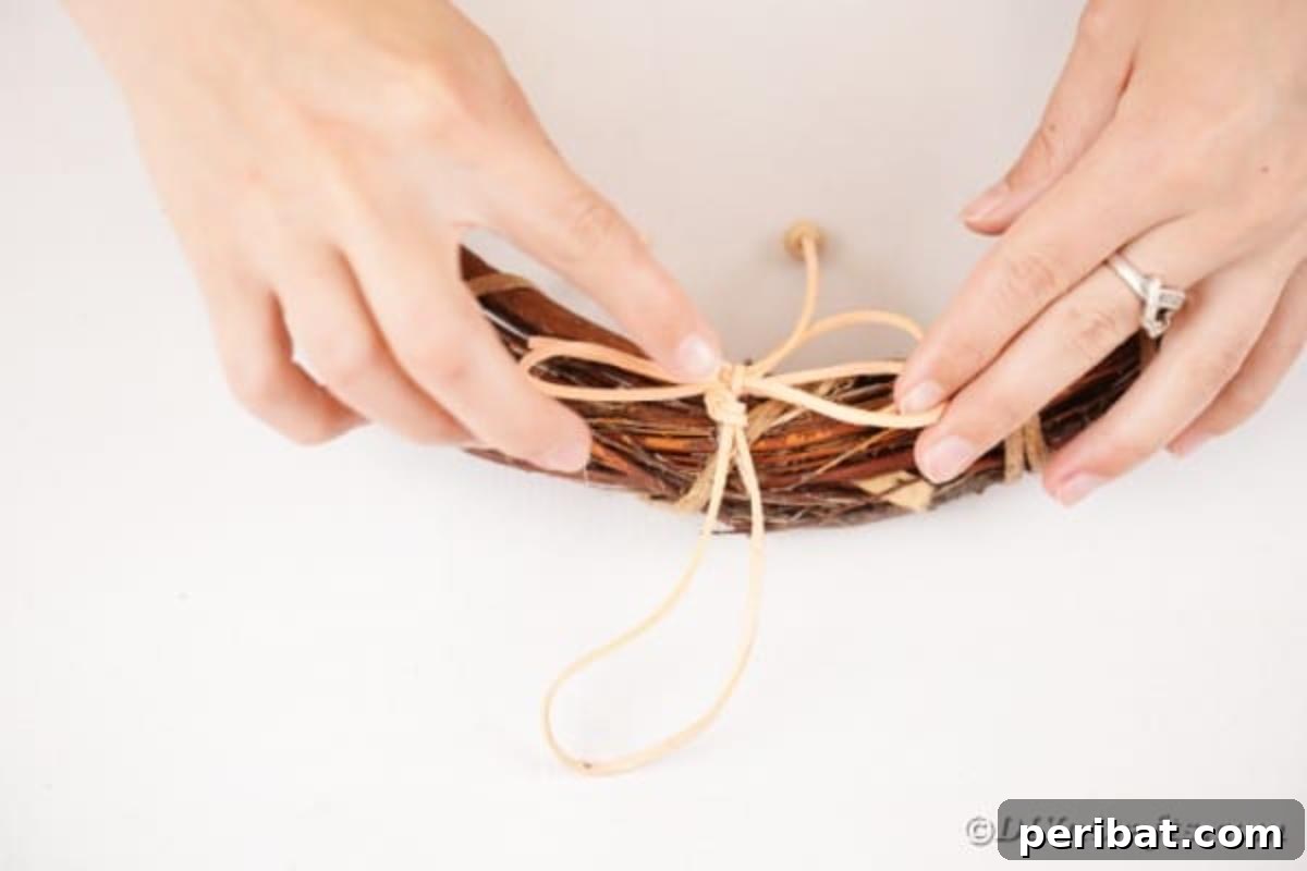 Autumn Grapevine Wreath with Soft Fabric Blooms 21 Gluing bow onto grapevine wreath