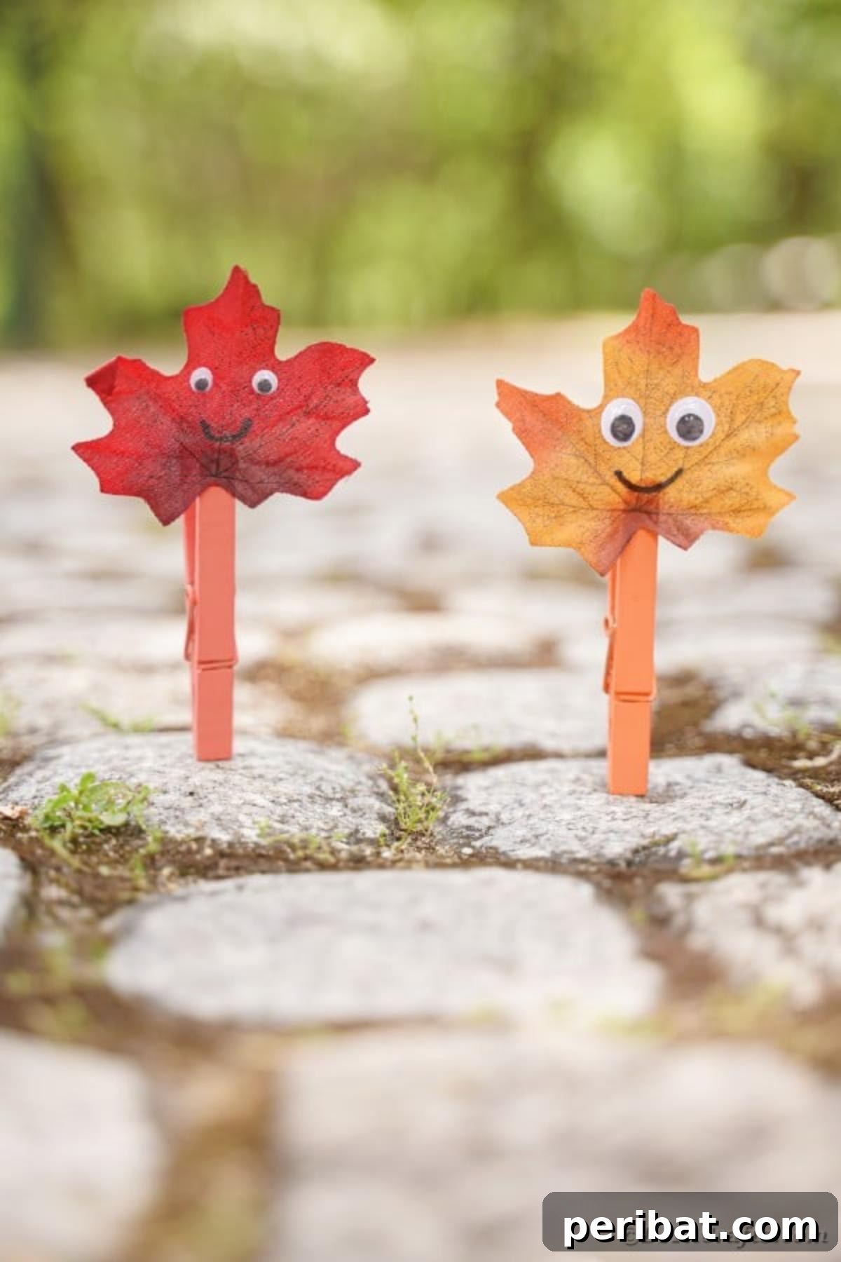 Geri Dönüşümle Sonbahar Yaprak İnsanlarını Canlandırın 18 Two cheerful fall leaf people crafts standing independently on a textured outdoor block walkway, ready for play or display.