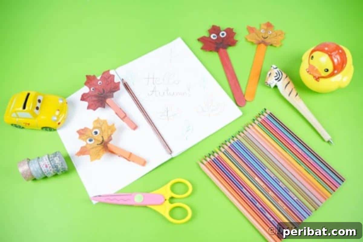 Geri Dönüşümle Sonbahar Yaprak İnsanlarını Canlandırın 6 Five fall leaf people crafts neatly arranged on a wooden desk alongside a book and pens, illustrating their charm as desk companions.