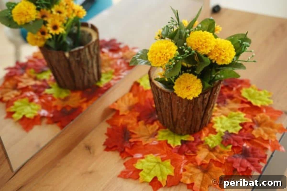 Close-up of a rustic stump flower pot centerpiece sitting on the DIY fall leaf placemat