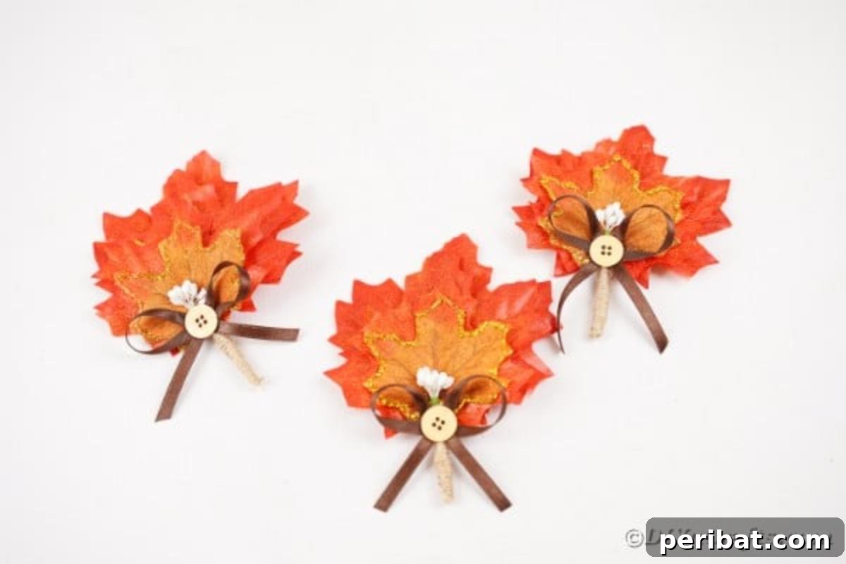 Elegant Autumnal Foliage Wedding Boutonnière 16 Several finished fall leaf boutonnieres artfully arranged on a clean white table, showcasing their completeness.