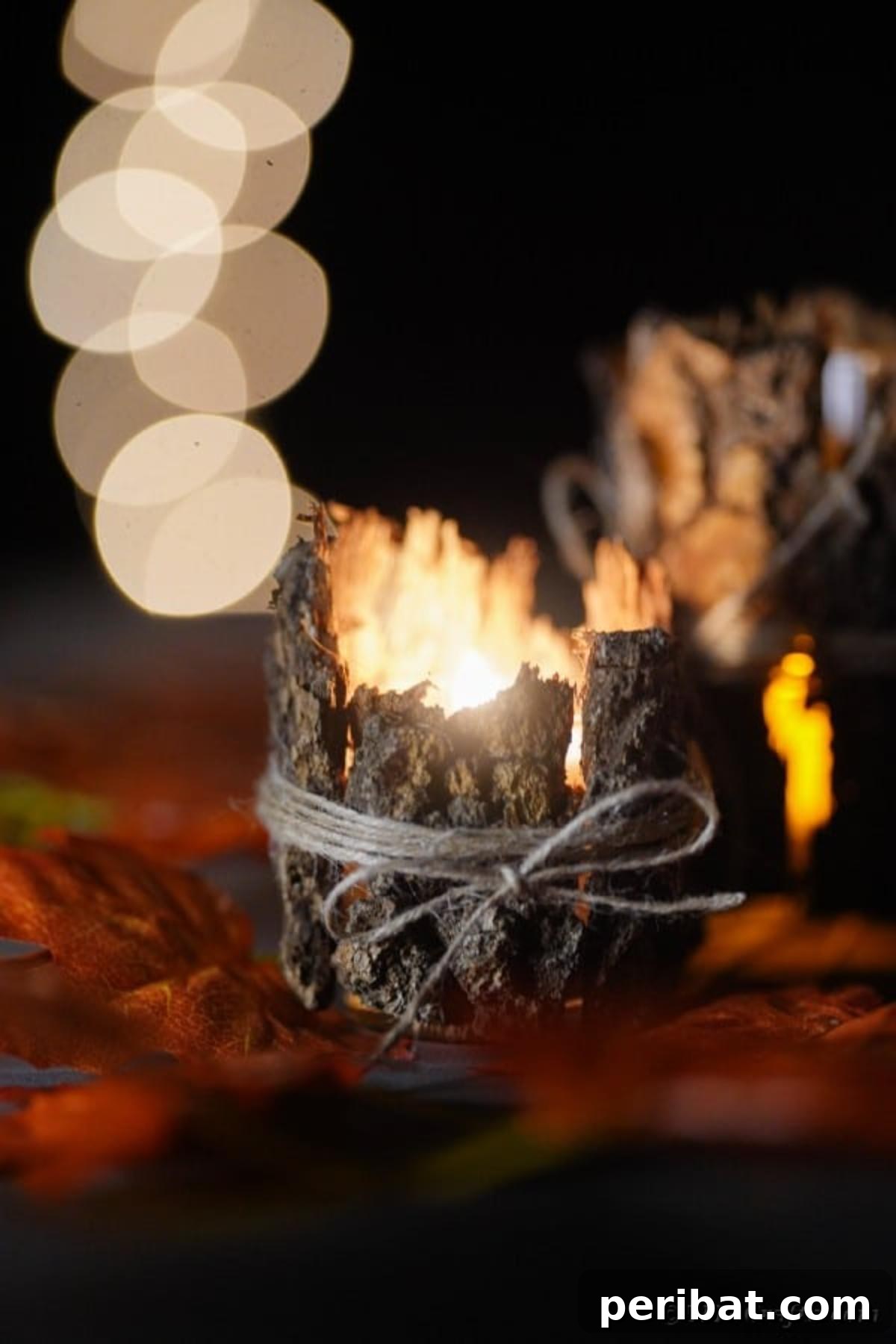 Woodland Hearth Bark Lantern 18 Close-up of three lit tree bark lanterns arranged on a surface, radiating a warm, cozy light