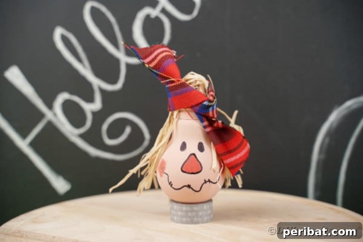 Charming Bulb Scarecrow Art from Recycled Lights 7 Lightbulb scarecrow on table by chalkboard