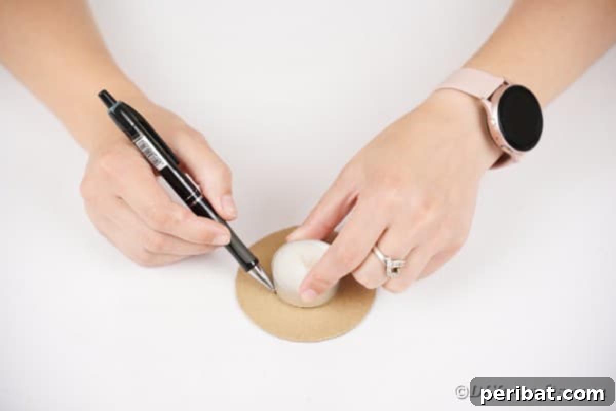 Artisanal Pistachio Shell Candle Holder 11 A candle being traced onto the center of a cardboard circle