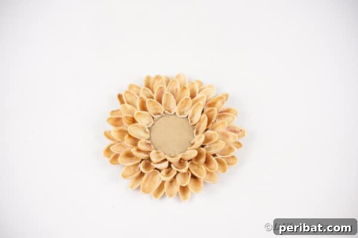 Artisanal Pistachio Shell Candle Holder 14 A fully assembled pistachio shell candle holder sitting on a clean white table