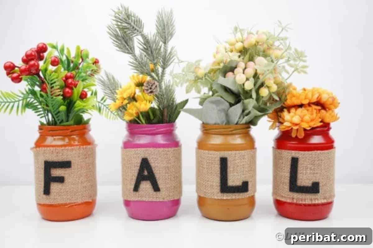 Cozy Farmhouse Fall Lettered Jars 3 Warm-toned fall mason jar decor spelling 'FALL' on a white table