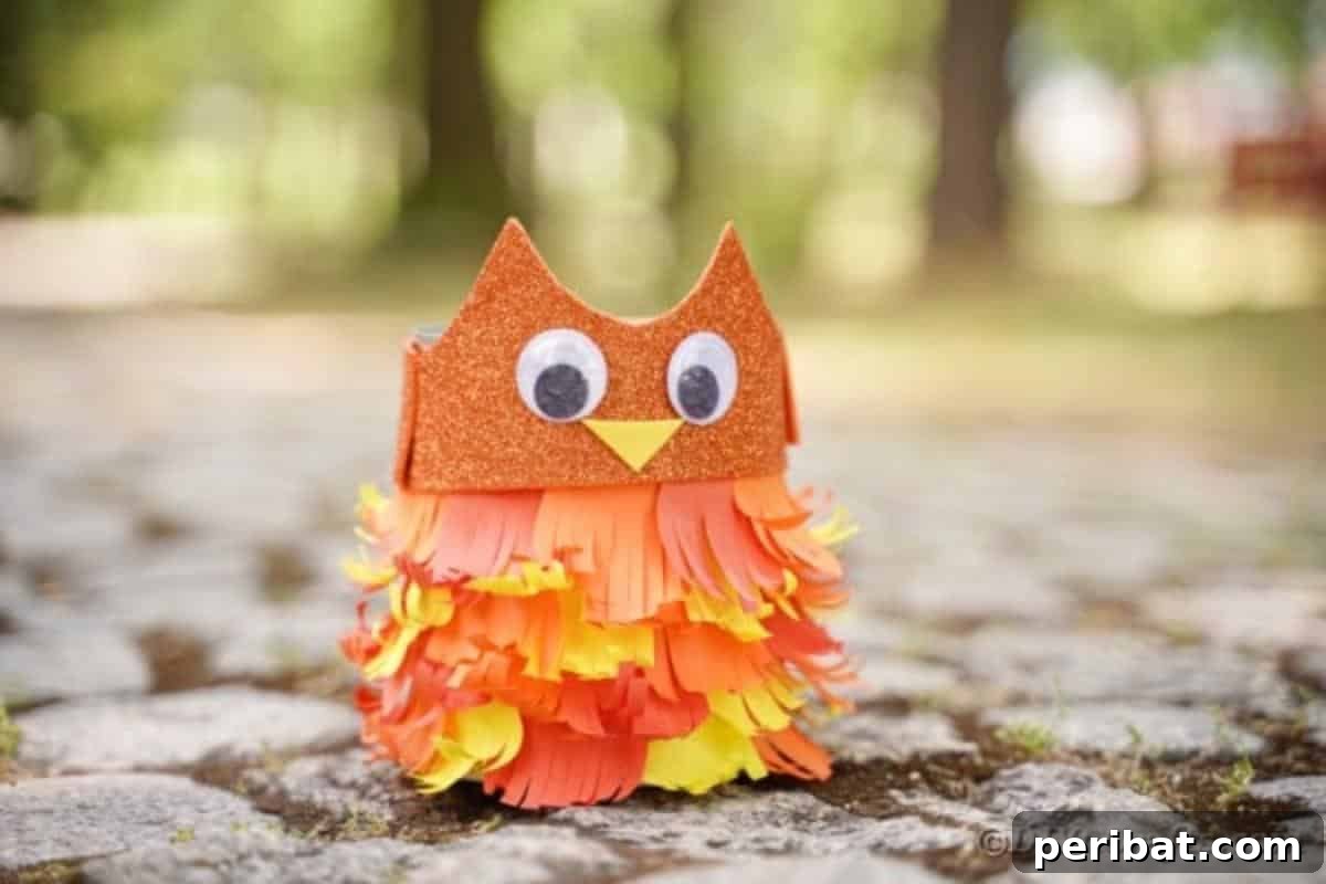 A person proudly holding their finished upcycled tin can owl, showcasing the craft from a closer perspective.