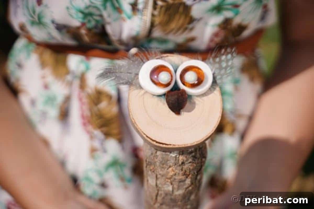 Whimsical Wooden Owls from Recycled Scraps Video Guide 6 A woman's hands gently hold a finished decorative wooden owl, showcasing its detailed eyes and natural wood texture, highlighting the craft's personal touch.