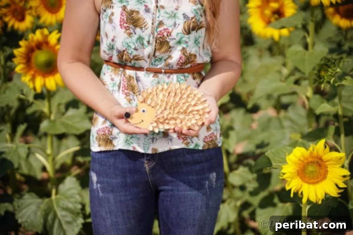 A woman's hands gently holding a completed hedgehog craft made from pistachio shells, highlighting the intricate texture against a blurred background.