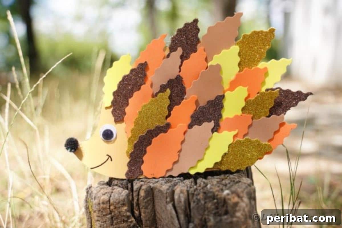 A colorful hedgehog craft made from various shades of paper leaves, sitting on a natural tree stump amidst autumn foliage.