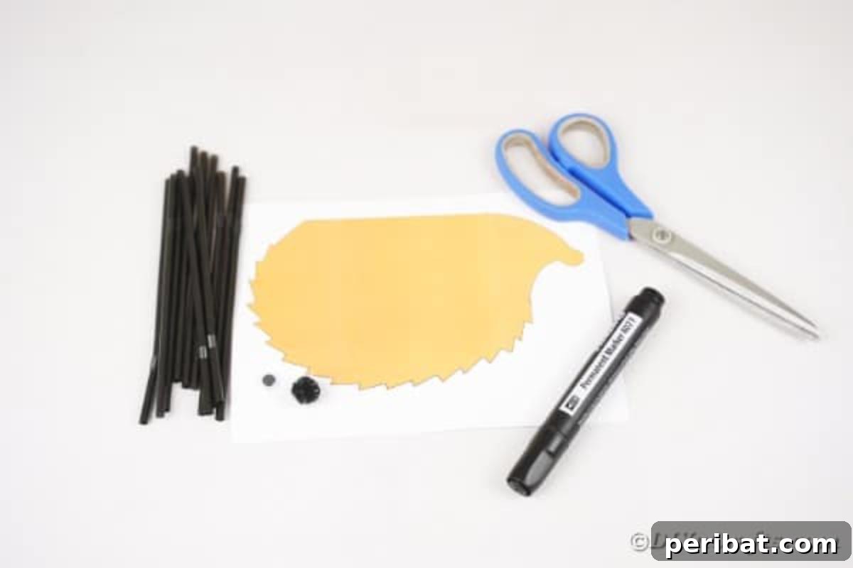 Various craft supplies laid out for creating a black straw hedgehog, including cut straws, glue gun, and the hedgehog template.