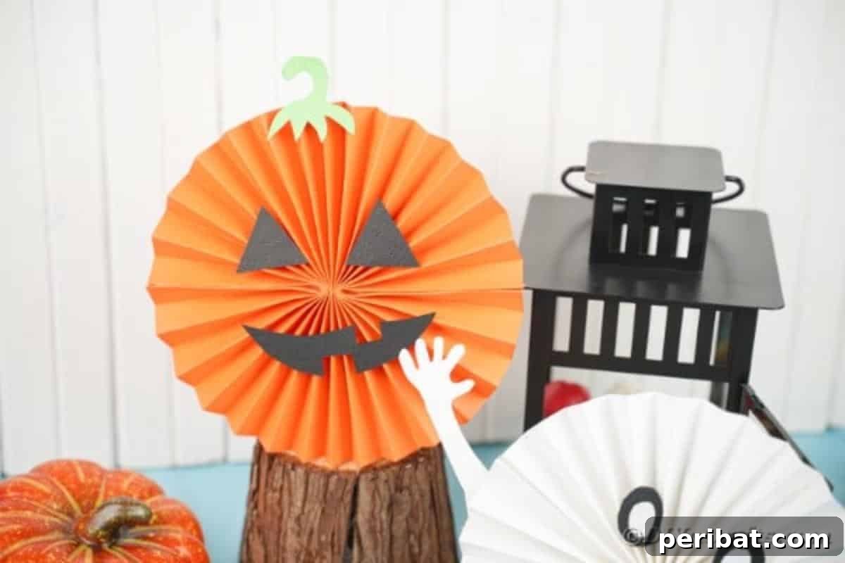 Fun and Easy Halloween Paper Fan Decor 25 Pumpkin paper fan by black lantern