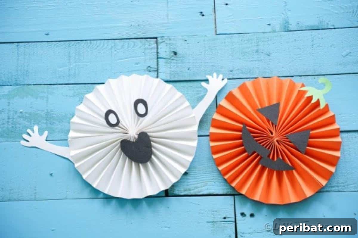 Fun and Easy Halloween Paper Fan Decor 4 Halloween paper fans on blue boards