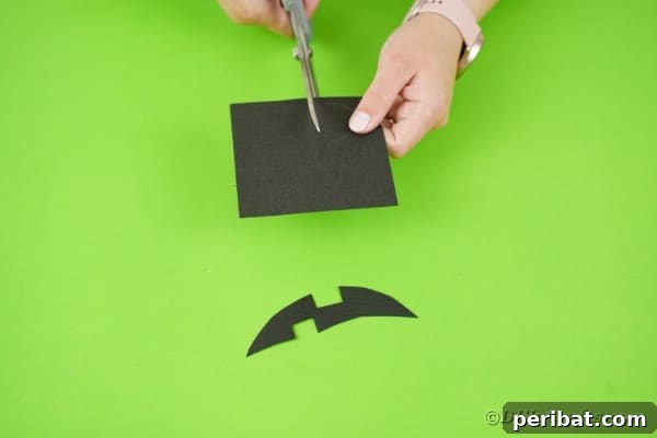 Fun and Easy Halloween Paper Fan Decor 36 Cutting face pieces out of black paper