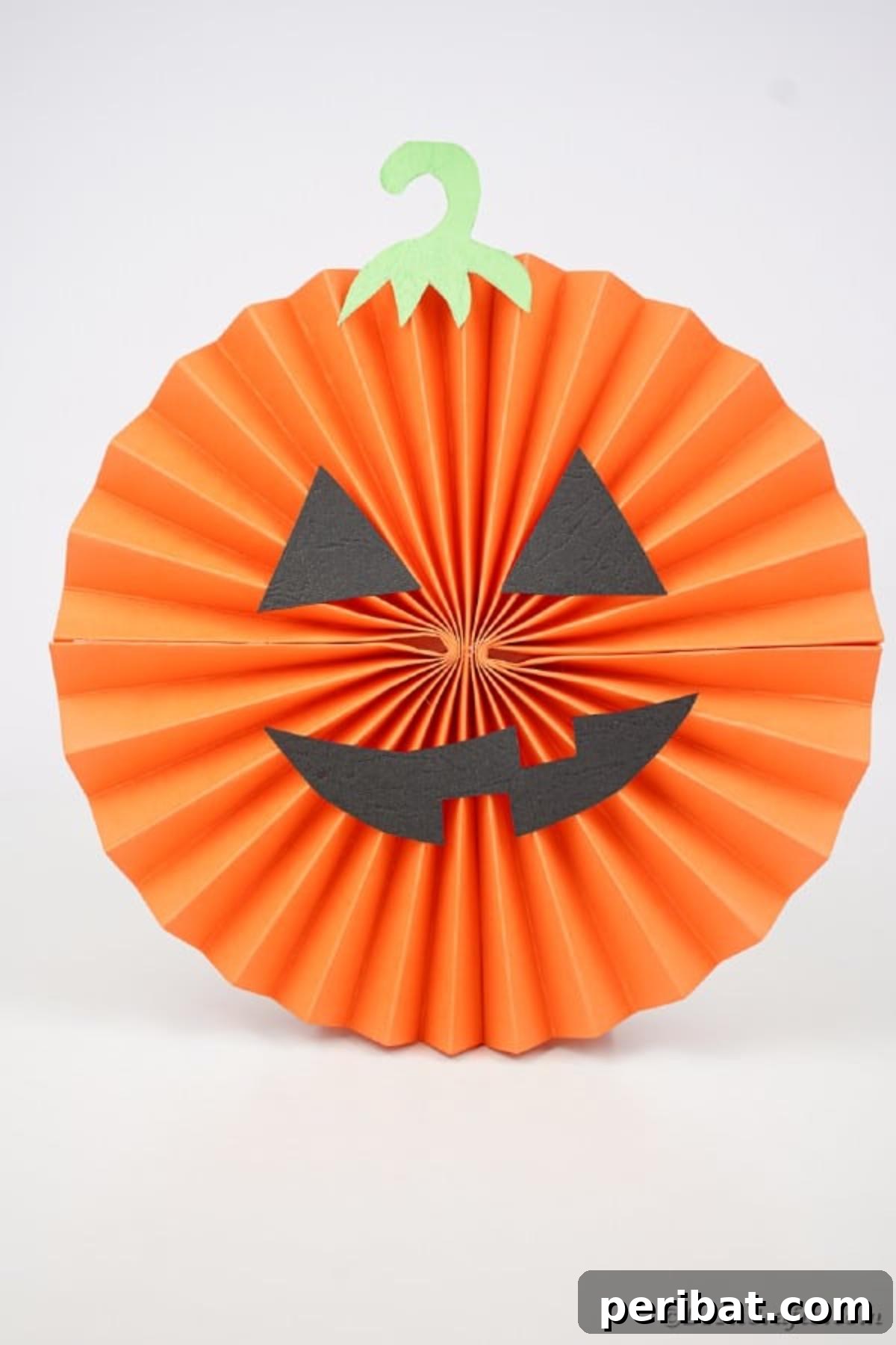 Fun and Easy Halloween Paper Fan Decor 43 Pumpkin paper fan on white surface