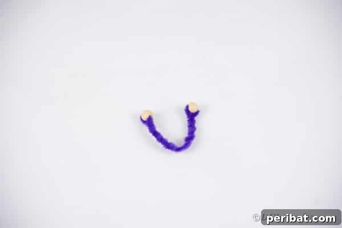 Spooktacular Clothespin Monster Craft 14 A twisted purple pipe cleaner with beads on the ends, forming monster arms