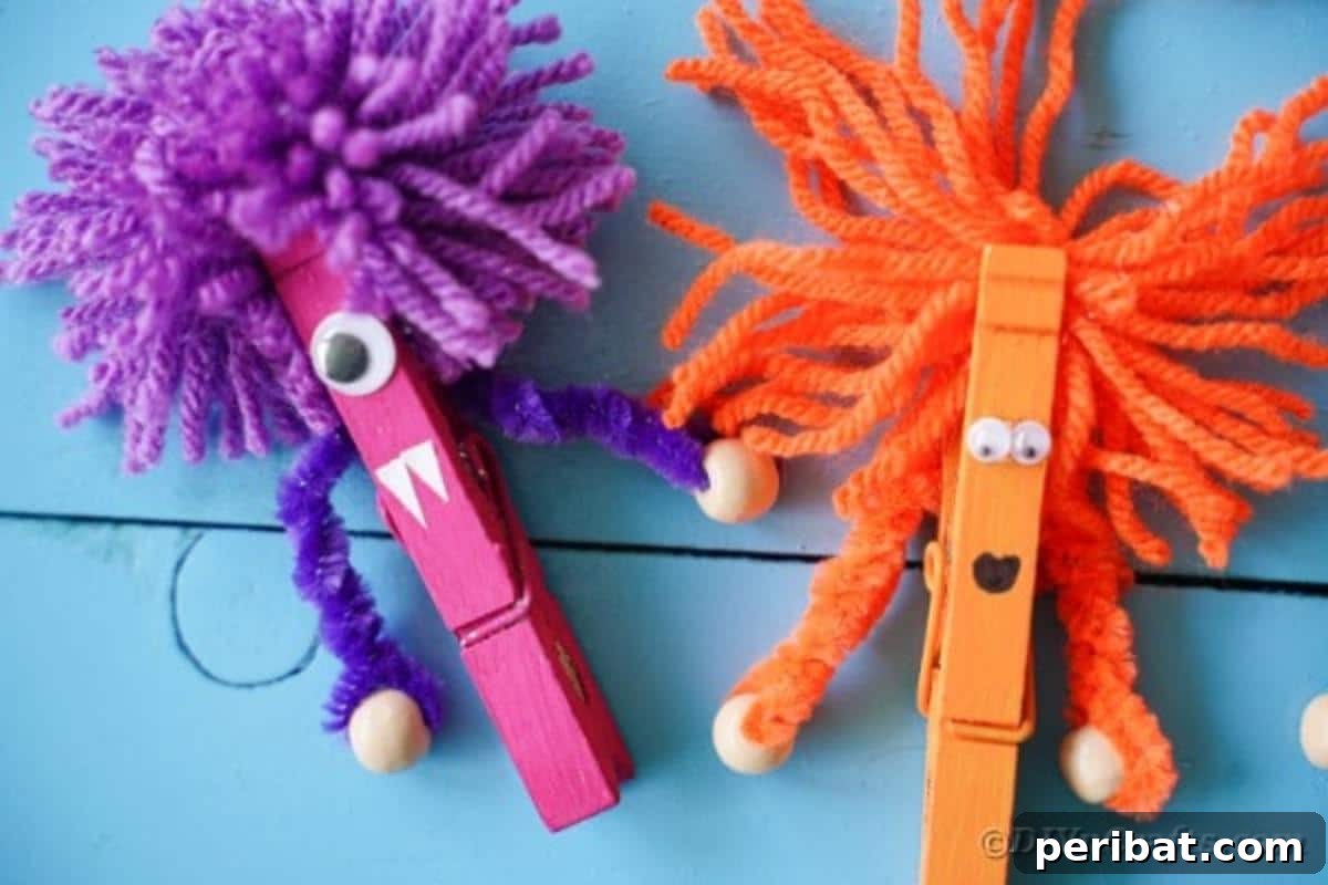 Spooktacular Clothespin Monster Craft 19 A collection of finished clothespin monsters standing on blue boards