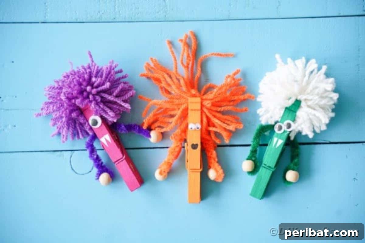 Spooktacular Clothespin Monster Craft 6 Five clothespin monsters standing on a blue surface, viewed from above