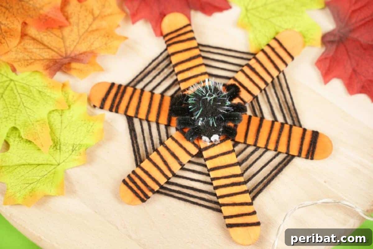 Spooky Stick Spiderwebs 4 A rustic craft stick spider web adorned with fall leaves, suggesting outdoor decor.